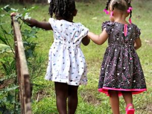 Two little girls walking away together as friends. Representing The Right to Feel Safe