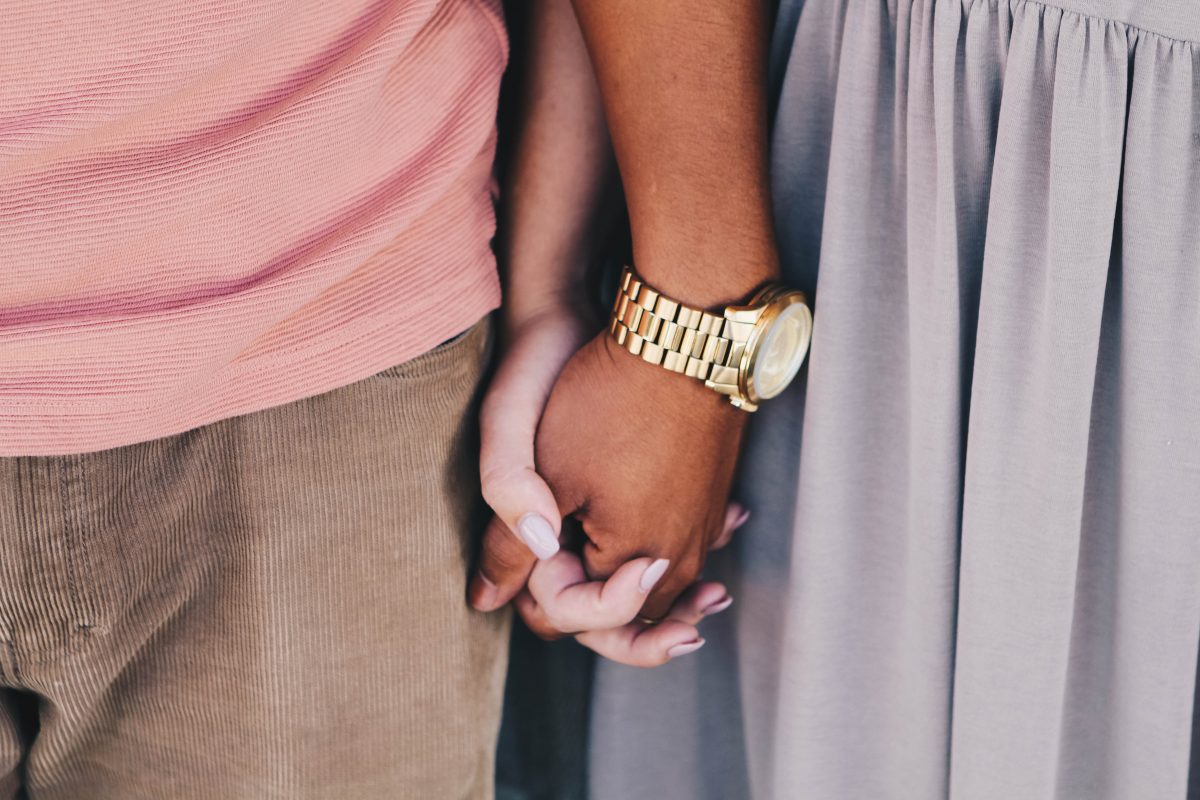 Two people holding hands, symbolising relationship education in primary schools.